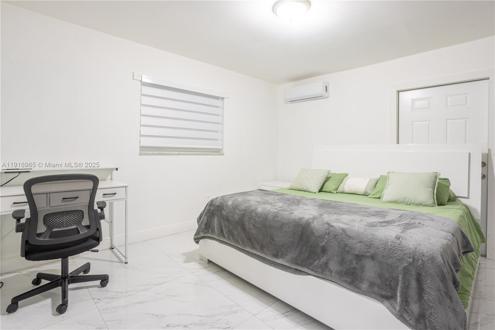 11510 Southwest 7th Street Sweetwater, FL 33174 - Photo 7 of 17 a bedroom with a bed and a chair