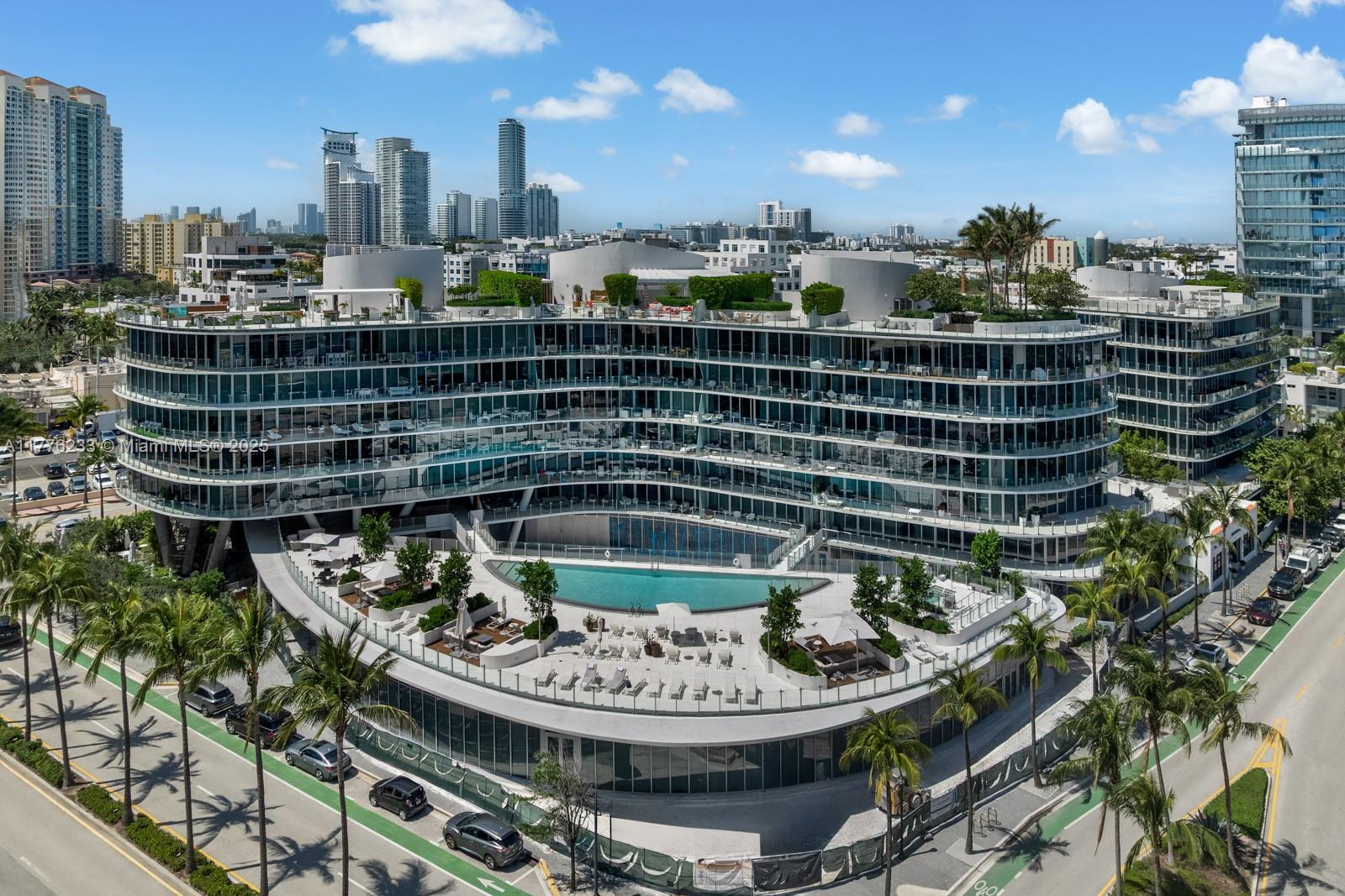 1 Collins Avenue, Unit 401 Miami Beach, FL 33139 - Photo 1 of 25 a picture of a table and chairs in patio
