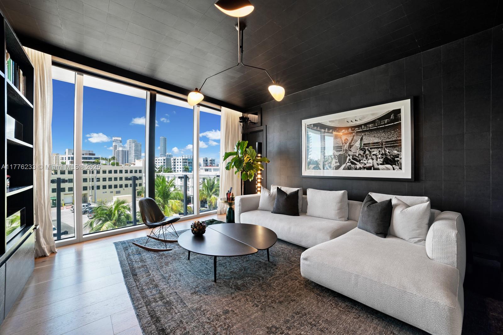 1 Collins Avenue, Unit 401 Miami Beach, FL 33139 - Photo 13 of 25 a living room with furniture a lamp and a potted plant