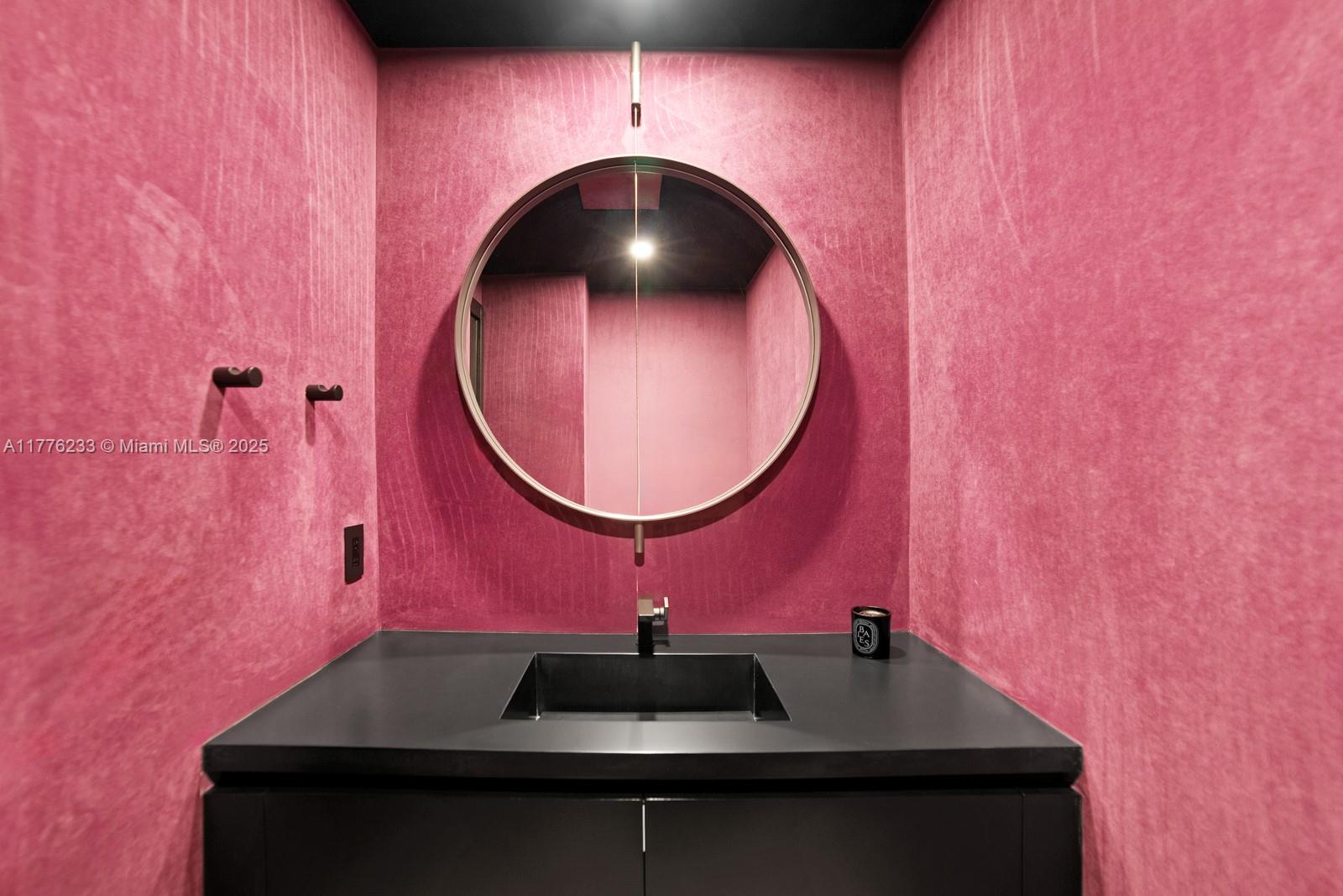 1 Collins Avenue, Unit 401 Miami Beach, FL 33139 - Photo 14 of 25 a bathroom with a sink and a mirror