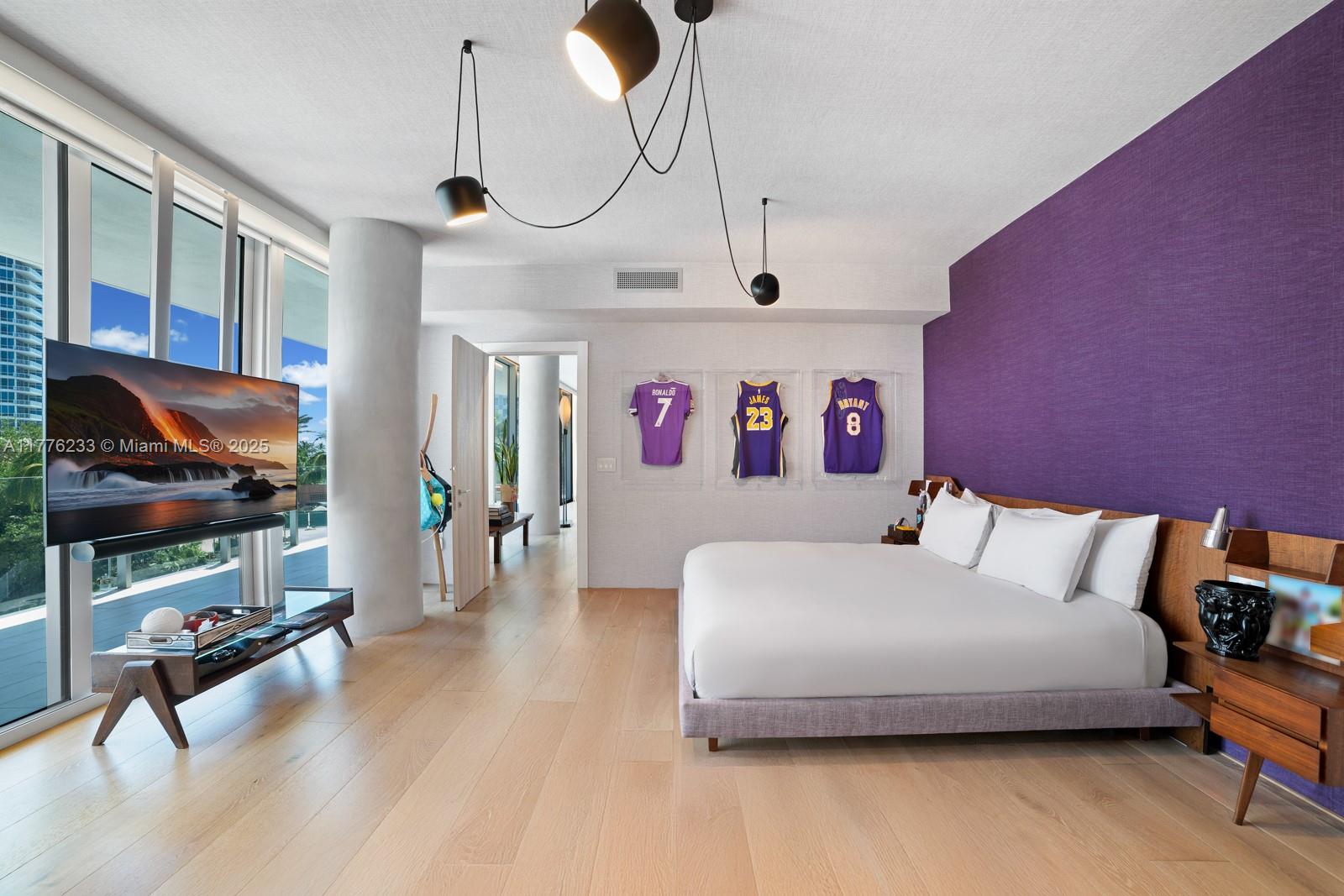 1 Collins Avenue, Unit 401 Miami Beach, FL 33139 - Photo 15 of 25 a bedroom with a bed and a chandelier