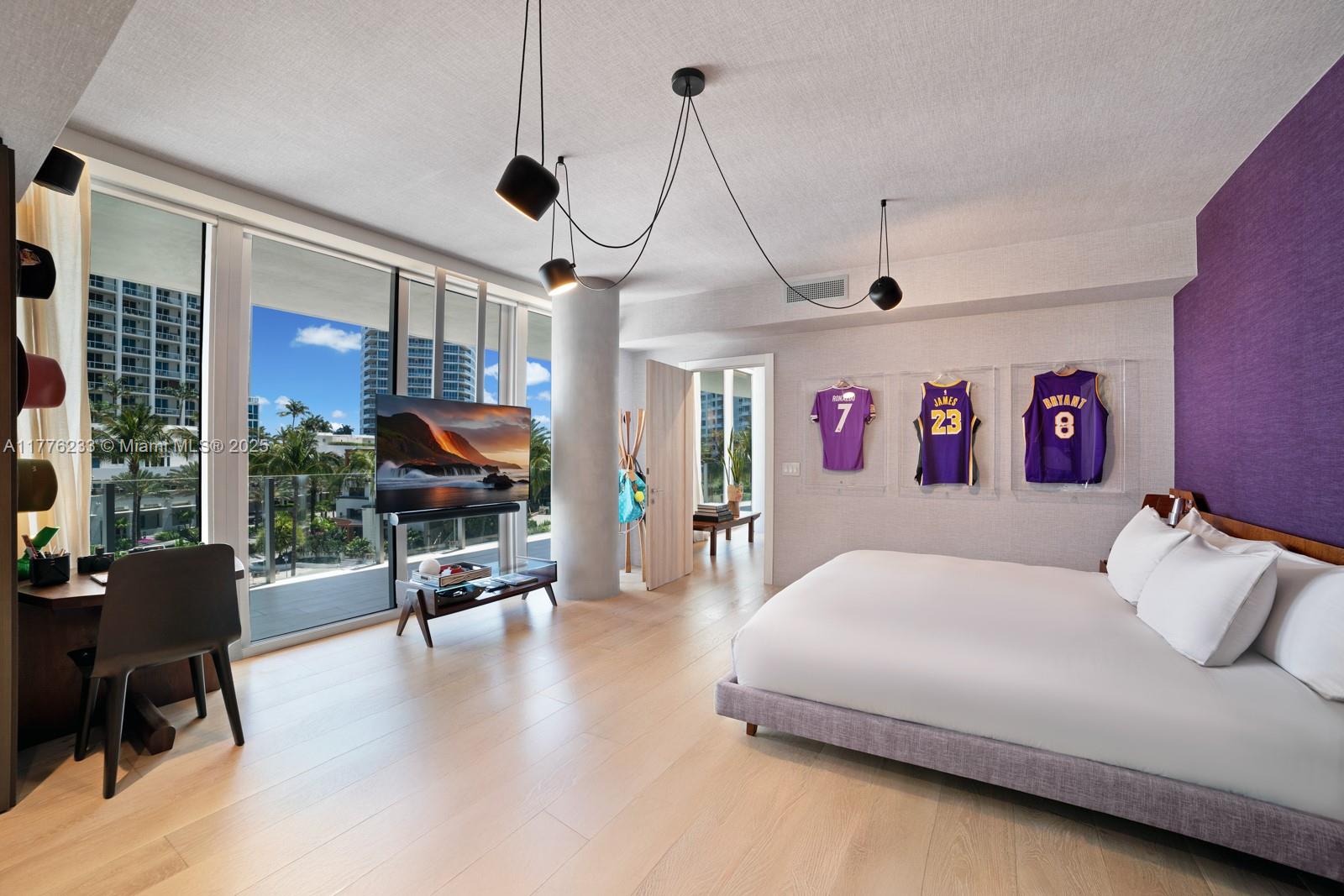 1 Collins Avenue, Unit 401 Miami Beach, FL 33139 - Photo 16 of 25 a bedroom with furniture and a chandelier