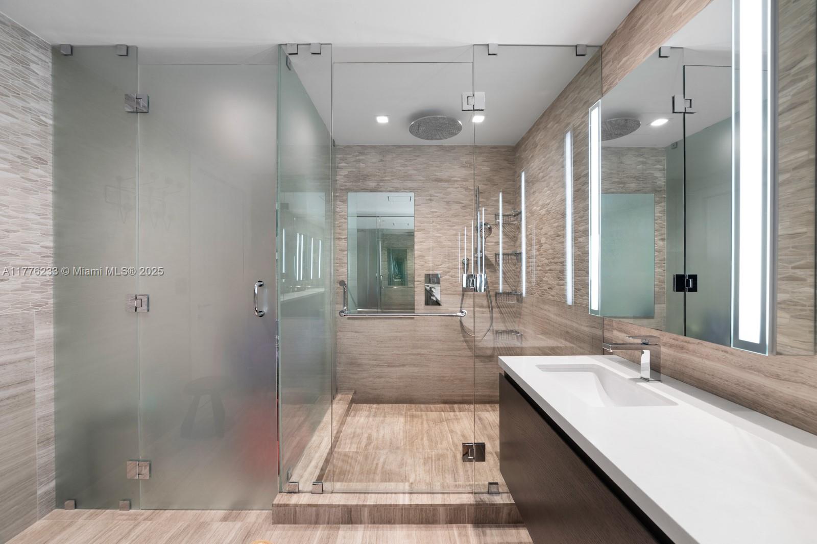 1 Collins Avenue, Unit 401 Miami Beach, FL 33139 - Photo 18 of 25 a bathroom with a sink a toilet and shower