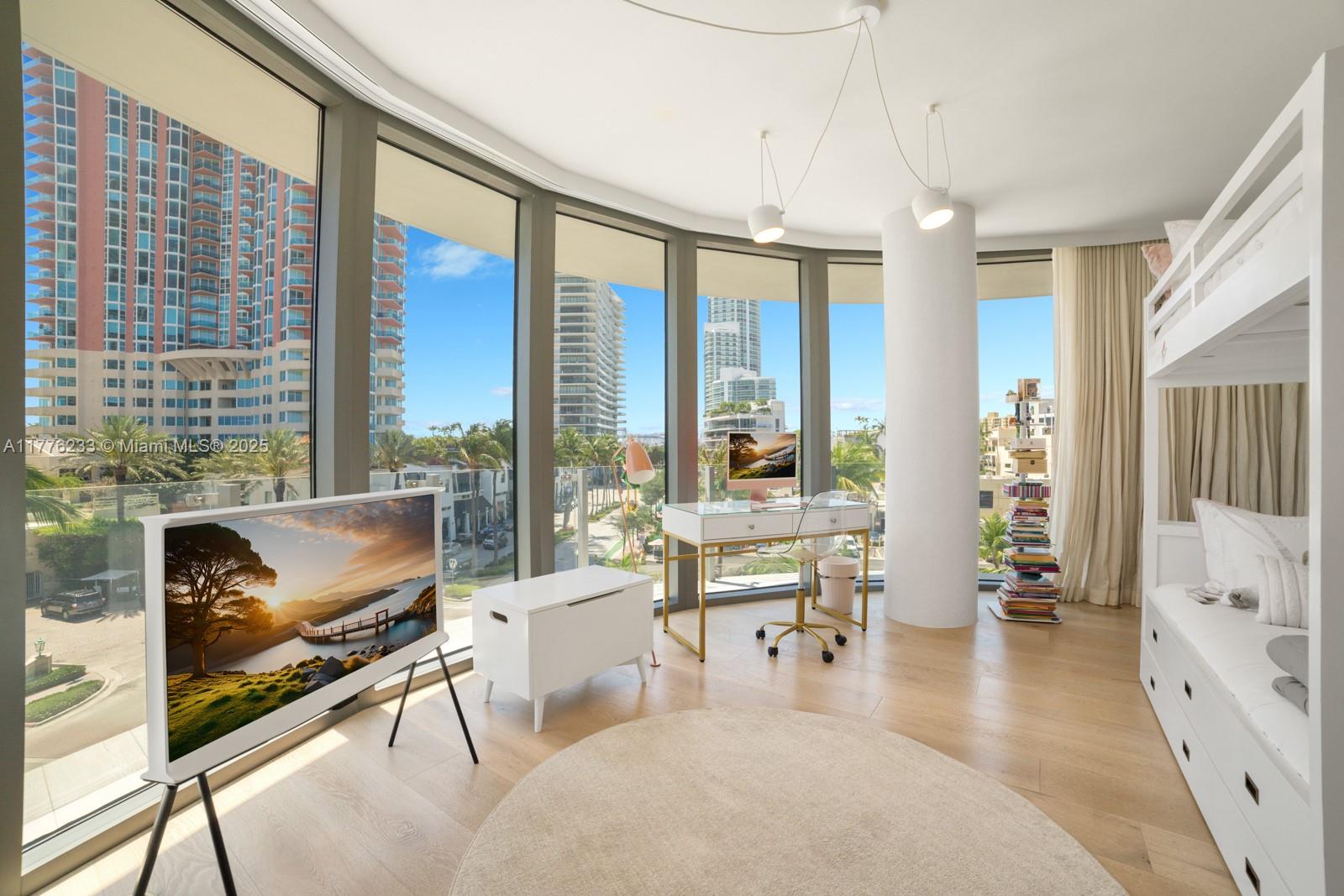 1 Collins Avenue, Unit 401 Miami Beach, FL 33139 - Photo 19 of 25 a living room with furniture and a flat screen tv