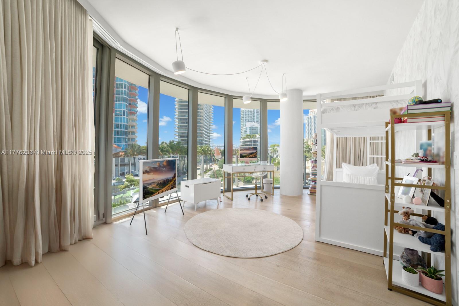 1 Collins Avenue, Unit 401 Miami Beach, FL 33139 - Photo 20 of 25 a living room with furniture a flat screen tv and a large window