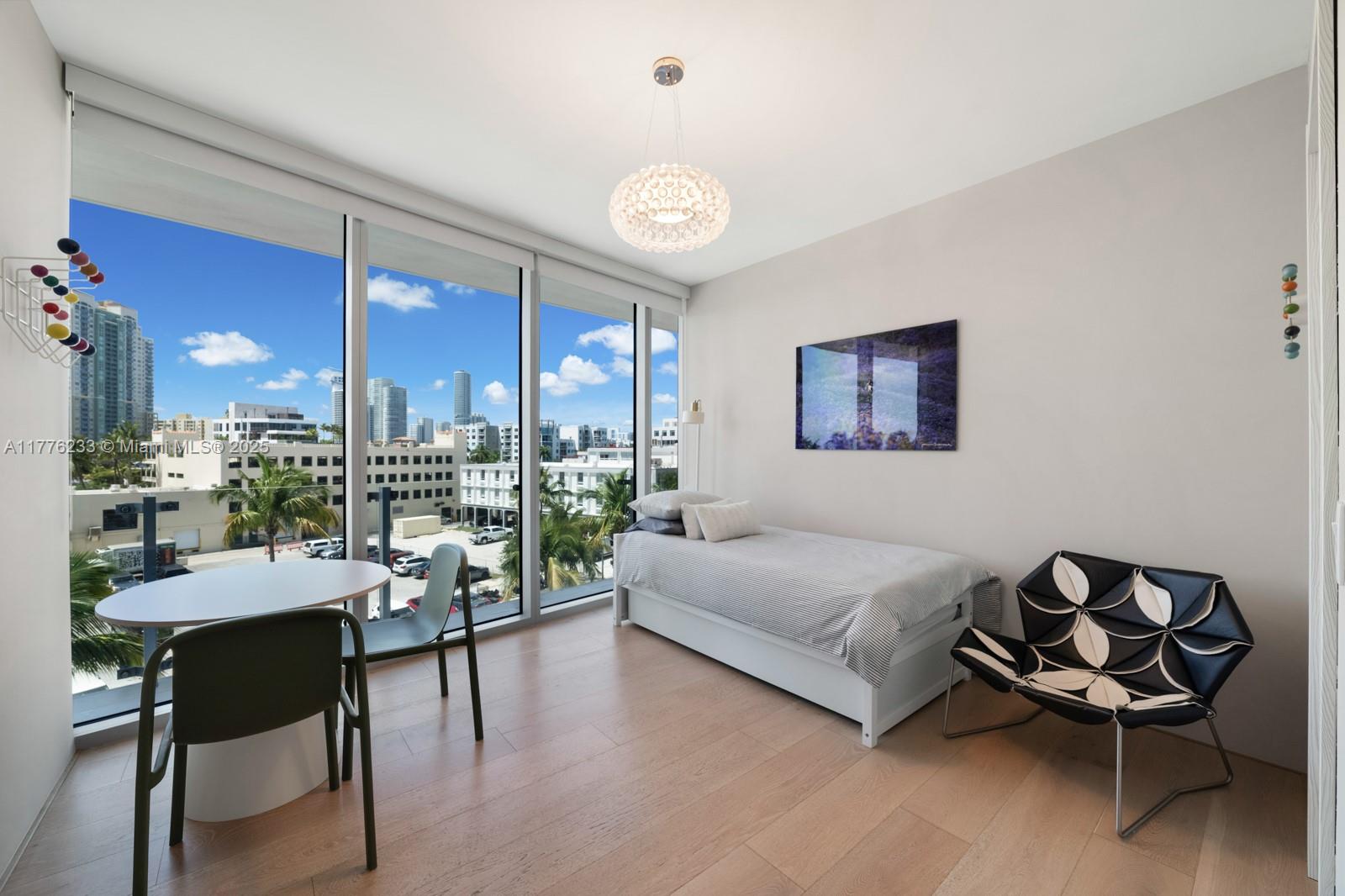 1 Collins Avenue, Unit 401 Miami Beach, FL 33139 - Photo 21 of 25 a living room with furniture and a large window