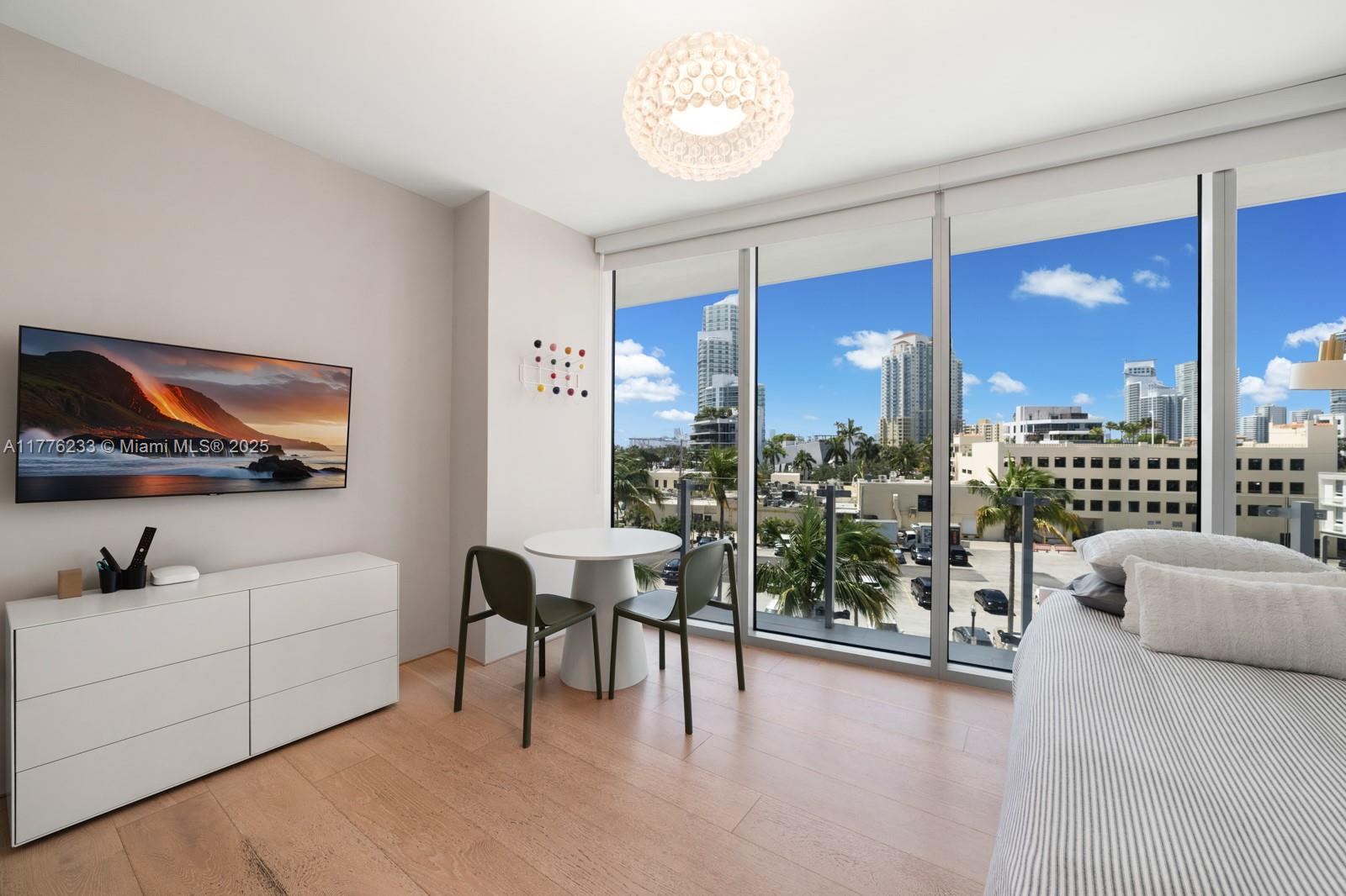 1 Collins Avenue, Unit 401 Miami Beach, FL 33139 - Photo 22 of 25 a living room with furniture and a flat screen tv