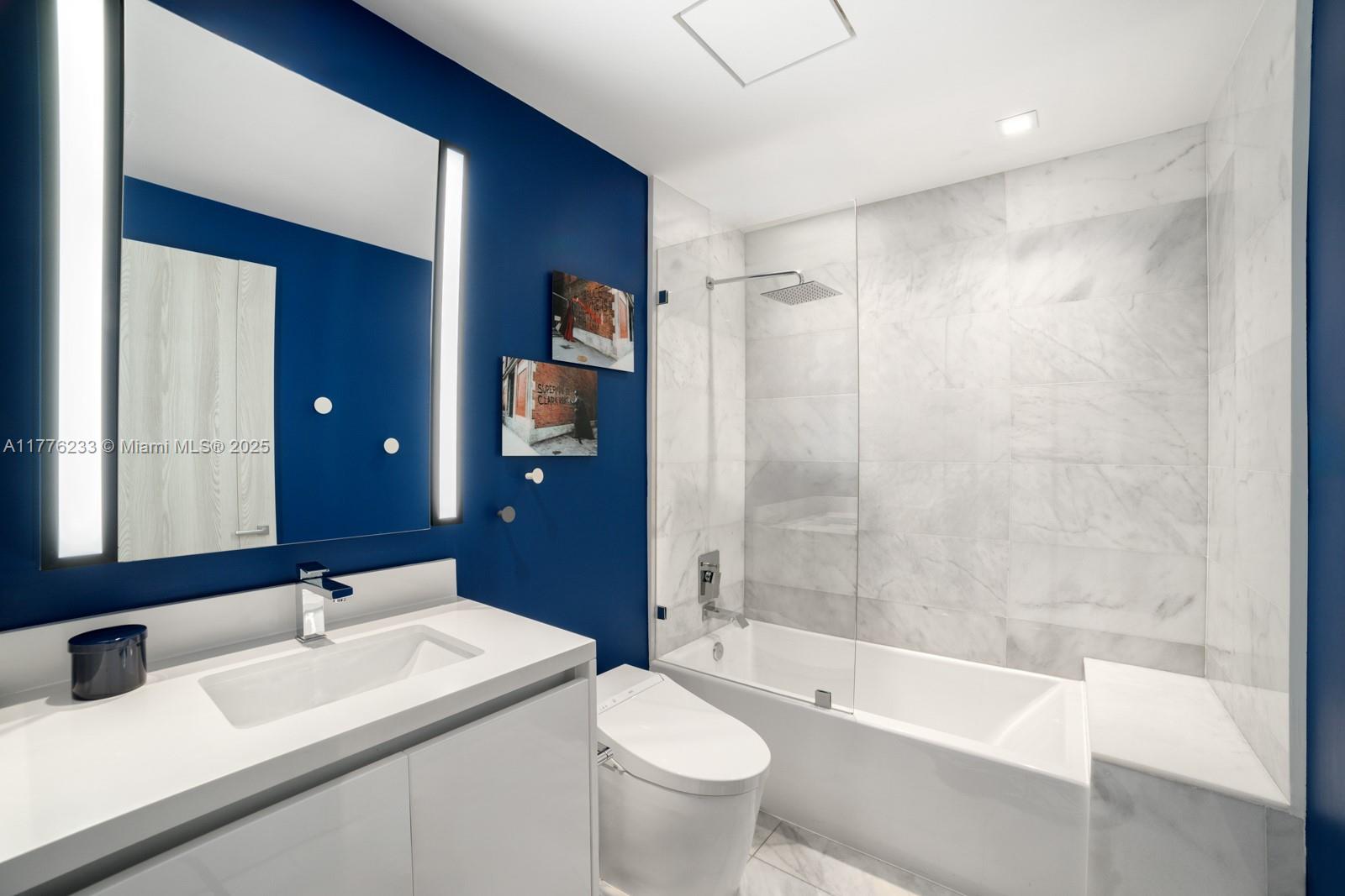 1 Collins Avenue, Unit 401 Miami Beach, FL 33139 - Photo 23 of 25 a bathroom with a sink toilet and shower