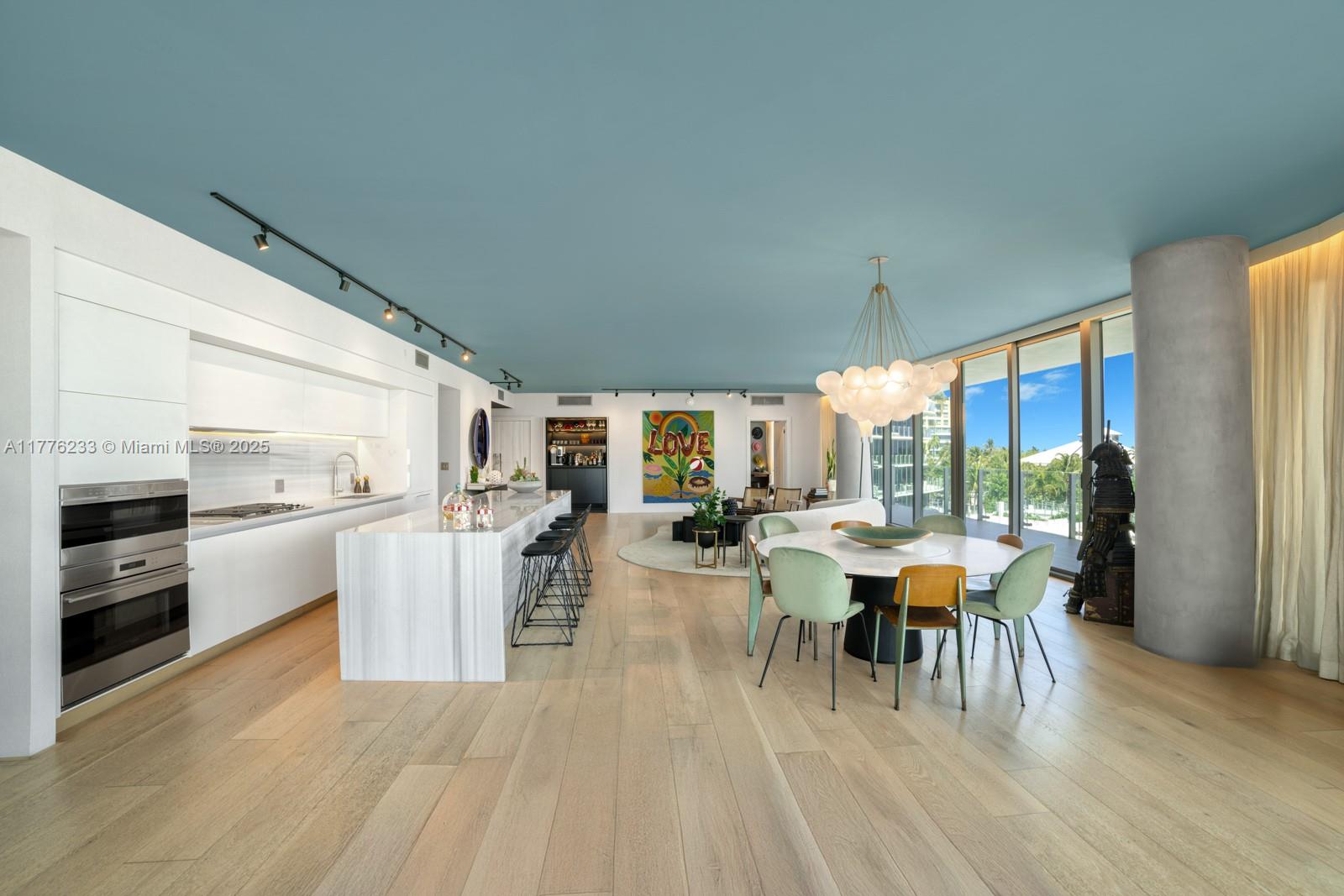 1 Collins Avenue, Unit 401 Miami Beach, FL 33139 - Photo 10 of 25 a view of a dining room with furniture window and outside view