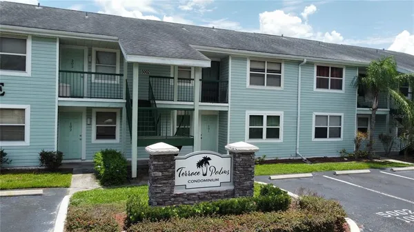 a front view of a house with a yard outdoor seating and garage