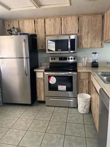 a kitchen with a stove a microwave and refrigerator