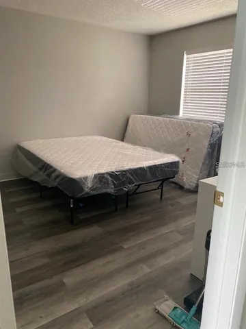 a bed sitting in a bedroom next to a window