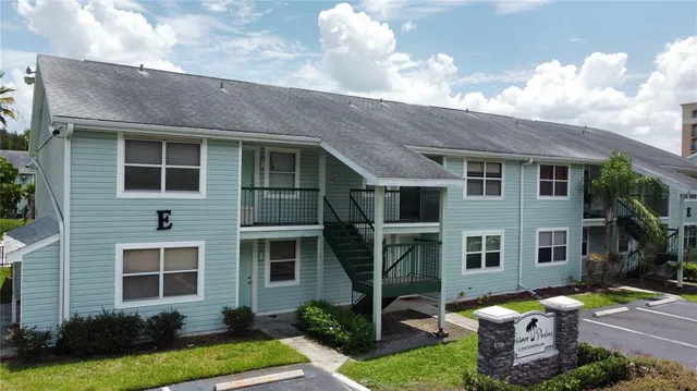 a front view of a house with garden and plants
