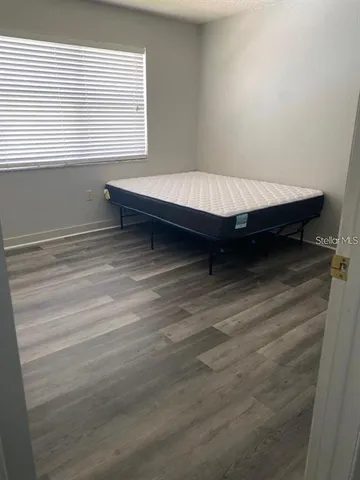 a bed sitting in a room next to a window