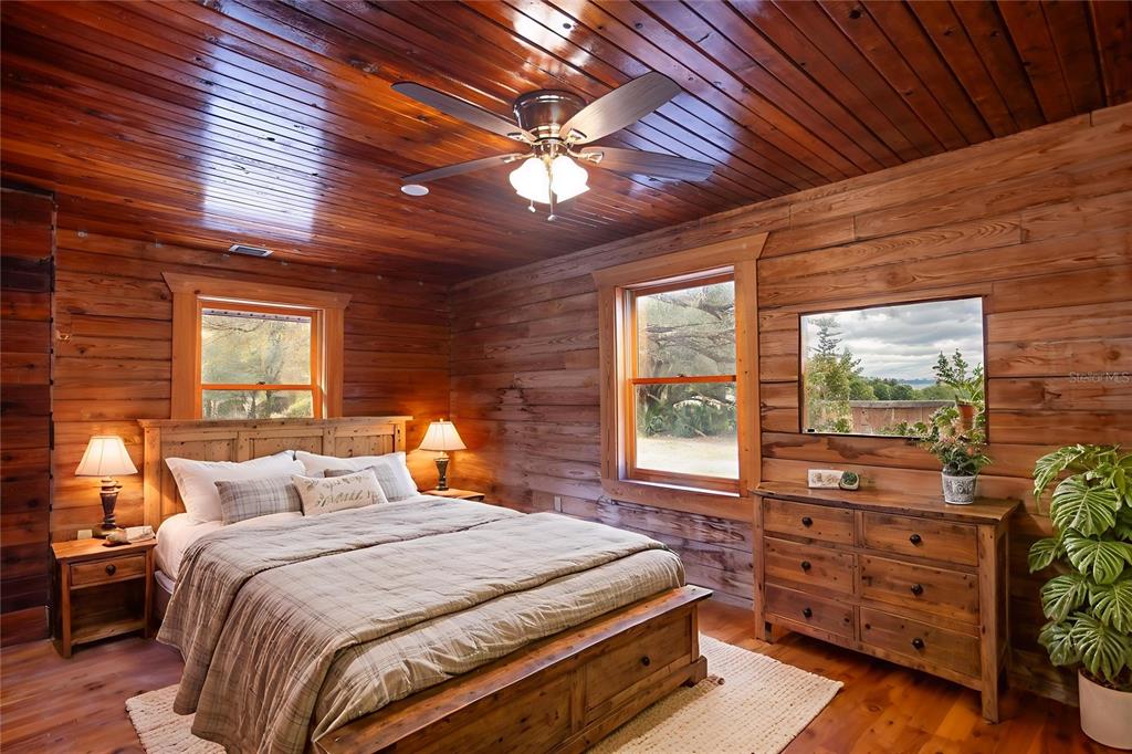 6892 Swain Road Sorrento, FL 32776 - Photo 16 of 57 a bedroom with a bed and a dresser next to a window