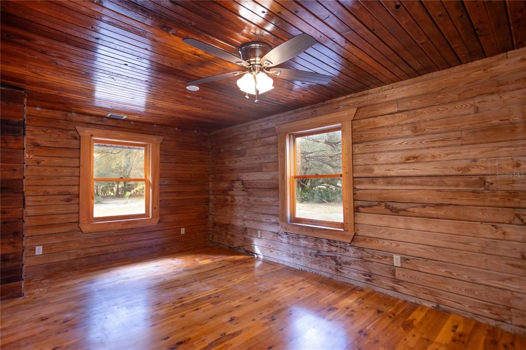 6892 Swain Road Sorrento, FL 32776 - Photo 17 of 57 a view of an empty room with wooden floor and a window