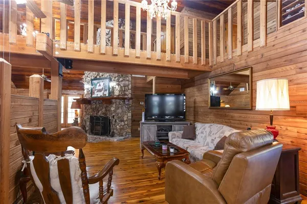 a living room with fireplace furniture and a flat screen tv