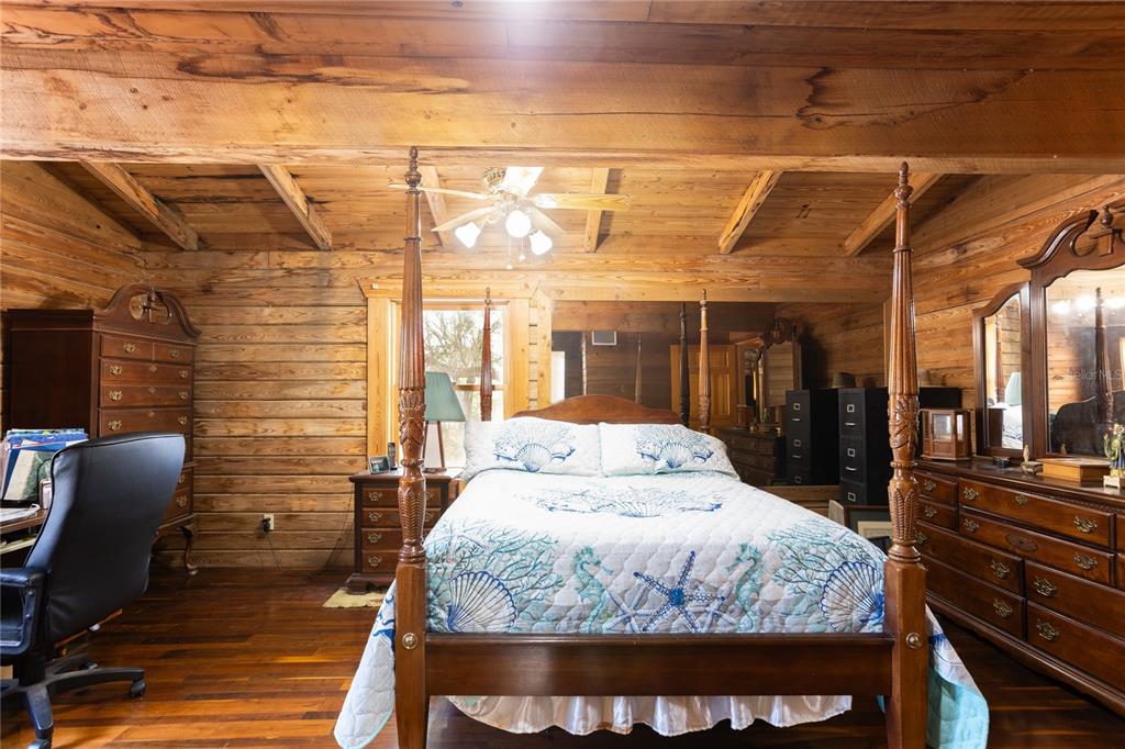 6892 Swain Road Sorrento, FL 32776 - Photo 48 of 57 a bedroom with a bed and wooden floor