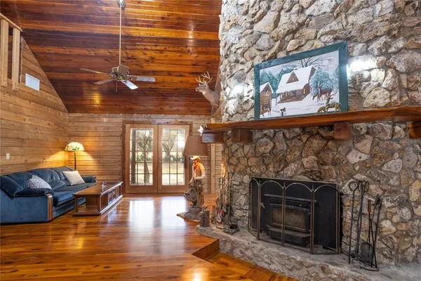 a living room with furniture a fireplace and a table