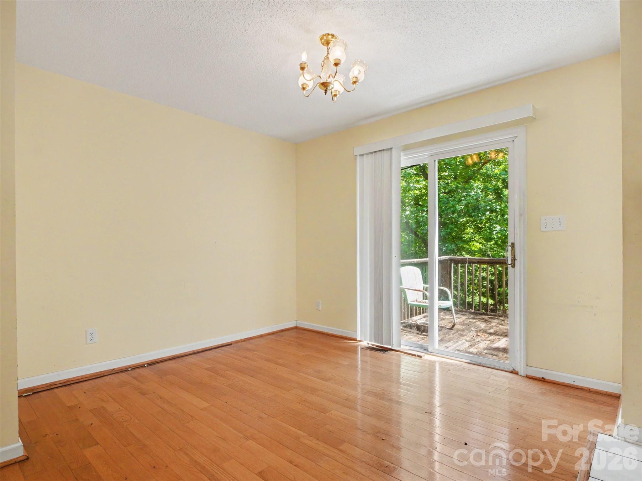 11109 Asbury Chapel Road Huntersville, NC 28078 - Photo 10 of 33 a view of a room with wooden floor and a window