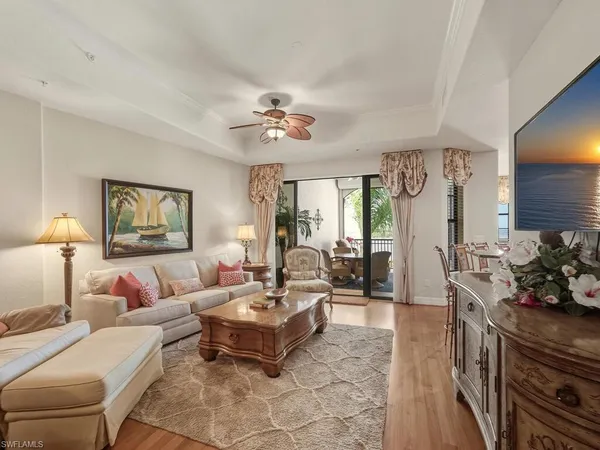 a living room with furniture potted plant and a chandelier