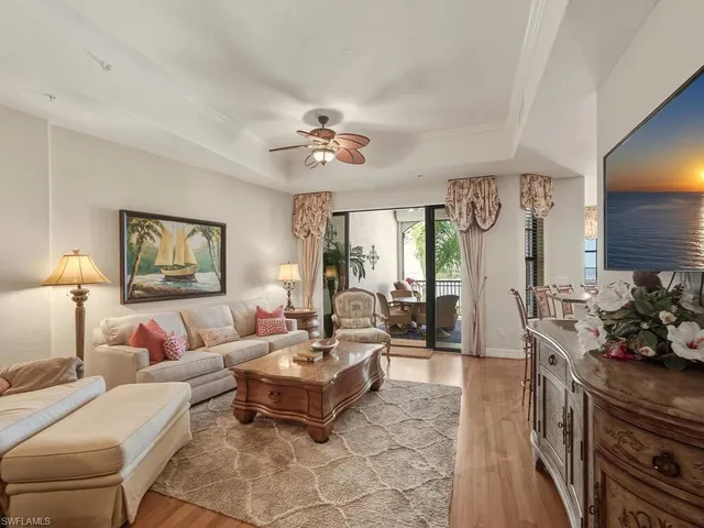 a living room with furniture potted plant and a chandelier