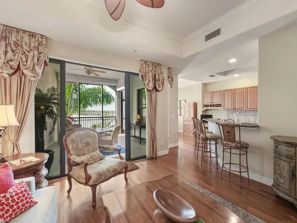 a living room with furniture and a floor to ceiling window