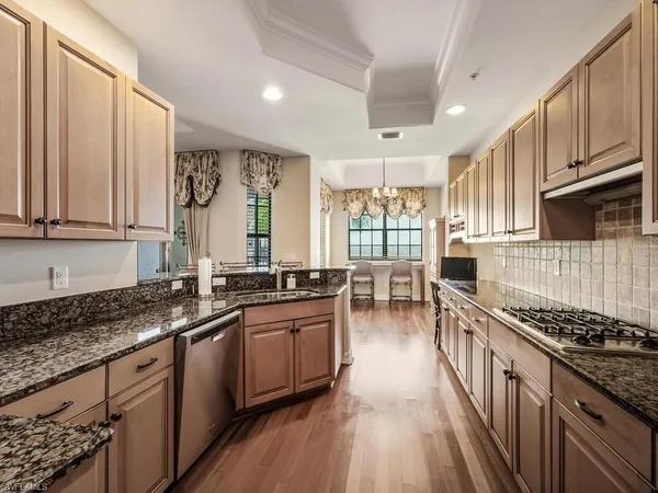 a kitchen with lots of counter top space a sink and appliances