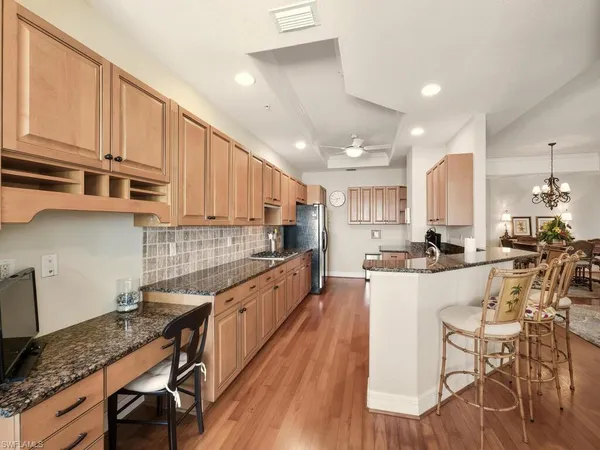 a large kitchen with stainless steel appliances lots of counter space and breakfast area