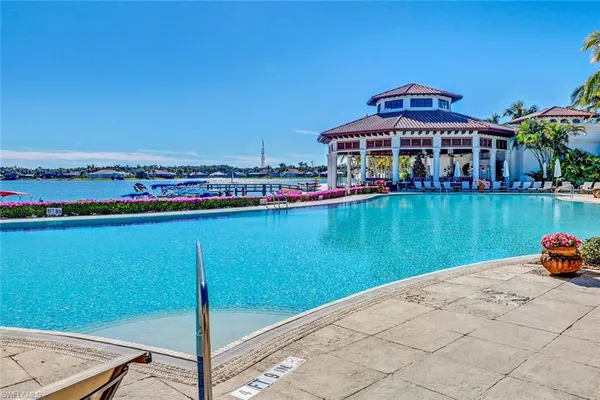 a view of a chairs and table in patio with a lake view