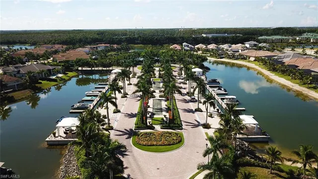 a view of a swimming pool with a lawn chairs and palm trees