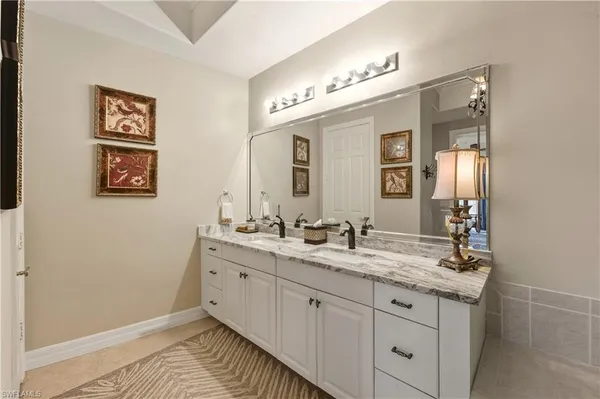 a bathroom with a double vanity sink and a mirror
