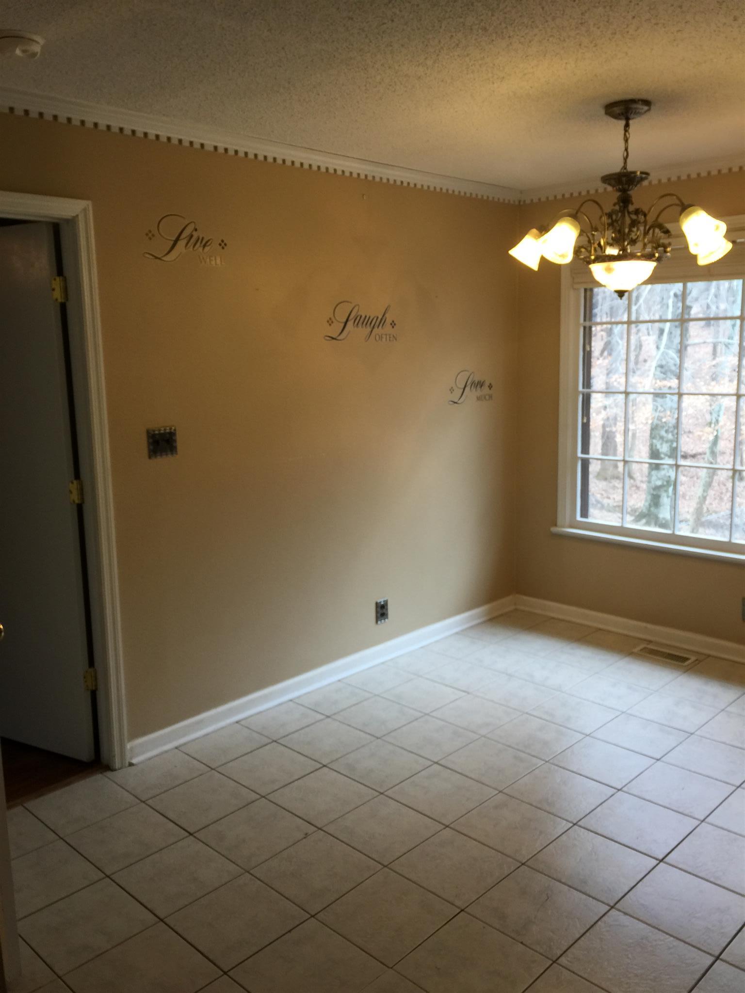 615 Bryan Road Clarksville, TN 37043 - Photo 7 of 22 en empty room with windows and chandelier