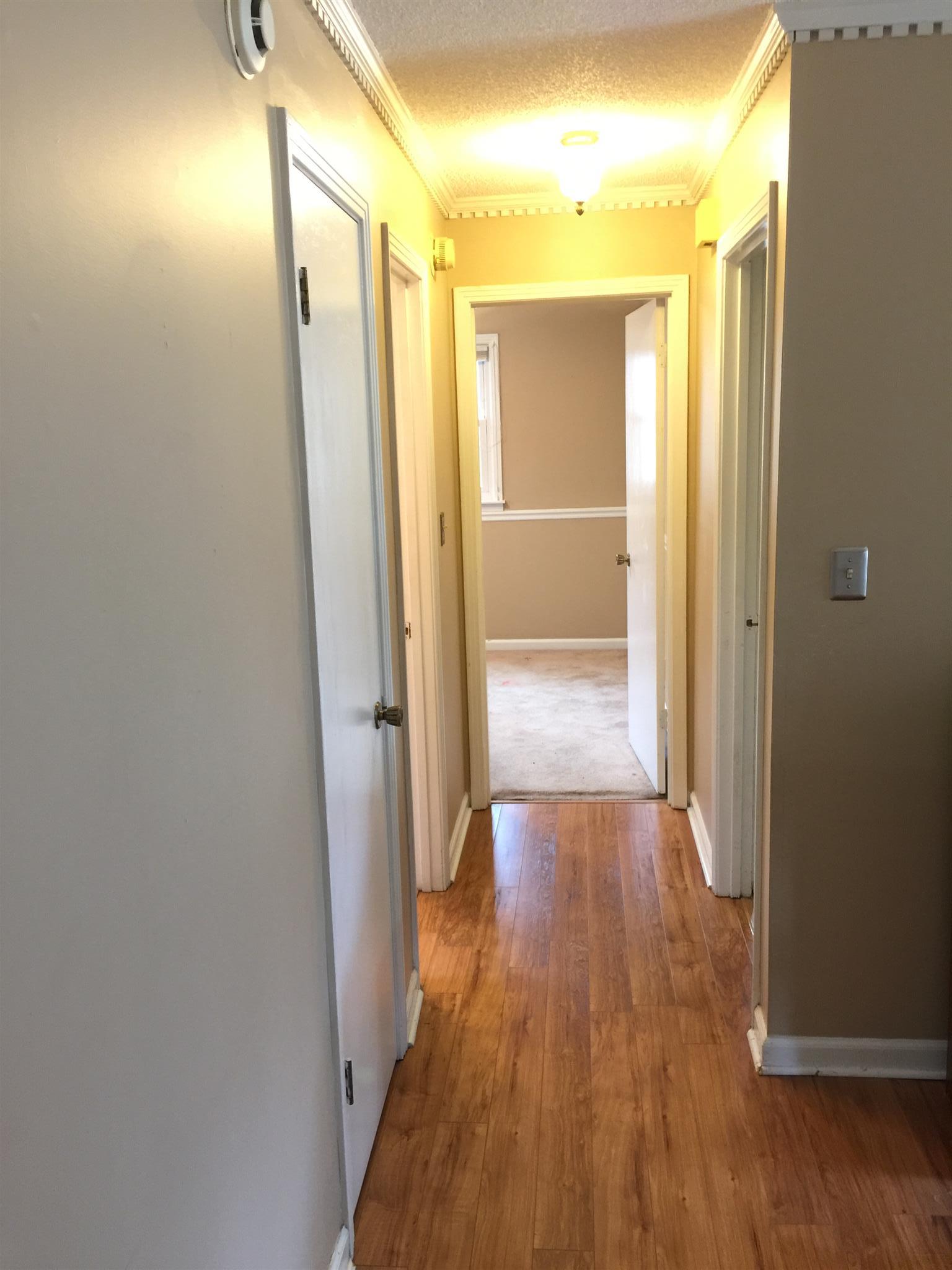 615 Bryan Road Clarksville, TN 37043 - Photo 8 of 22 a view of a hallway with wooden floor