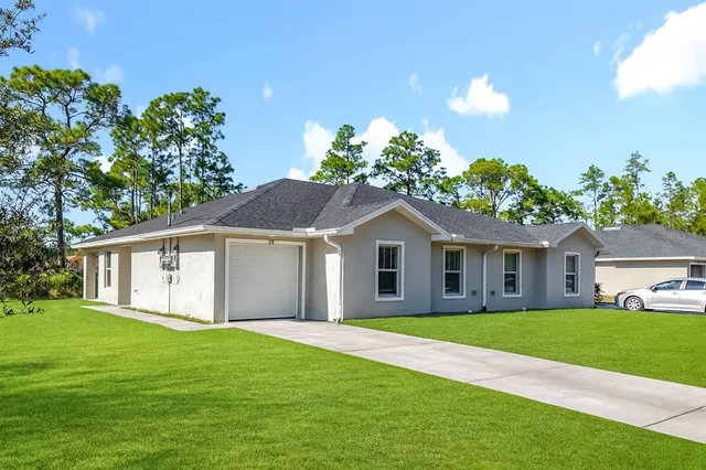 a view of house with a garden
