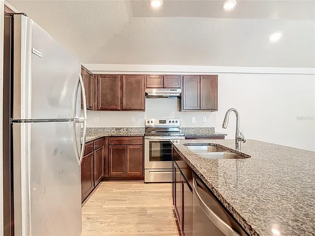 a kitchen with a sink and a stove top oven