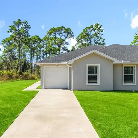 a front view of house with yard and green space