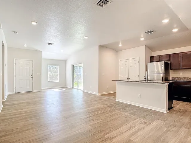 a view of kitchen with wooden floor
