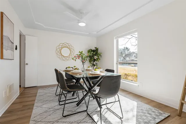 a view of a dining room with furniture and window