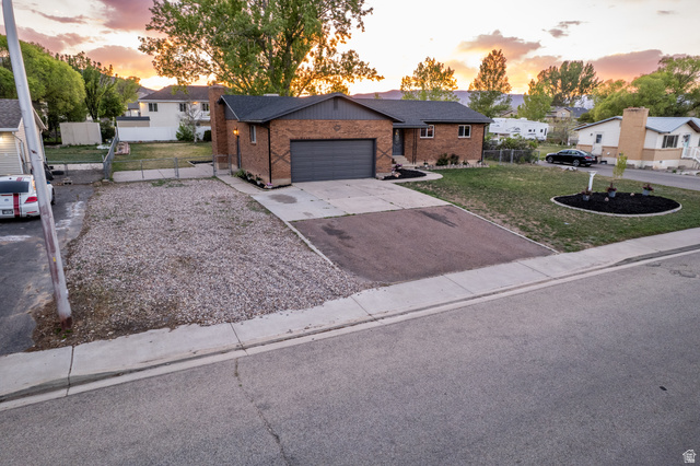 634 South 2100th Street West Vernal, UT 84078 - Photo 68 of 71 Brick exterior facade with a dark gray garage door