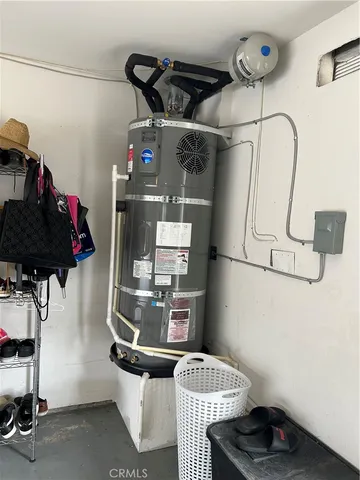a room with water heater and utility racks