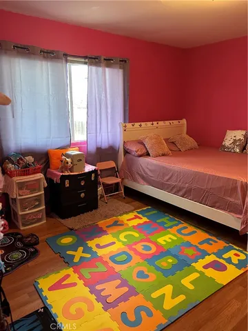 a bedroom with a bed and a tv