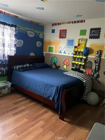 a bedroom with bed and window