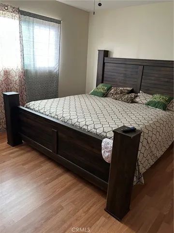 a bed sitting in a bedroom next to a window