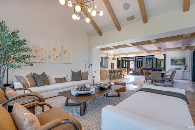 a large kitchen with stainless steel appliances kitchen island granite countertop a sink and cabinets