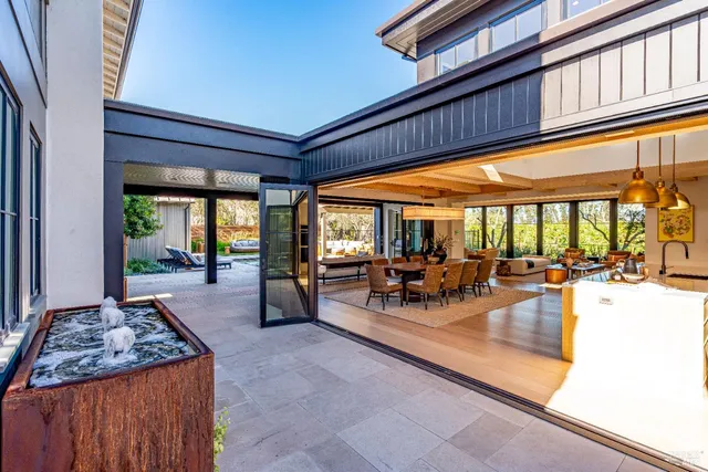 a view of a patio with chairs and floor to ceiling window