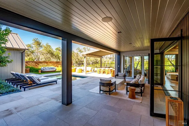 a living room with furniture and large windows