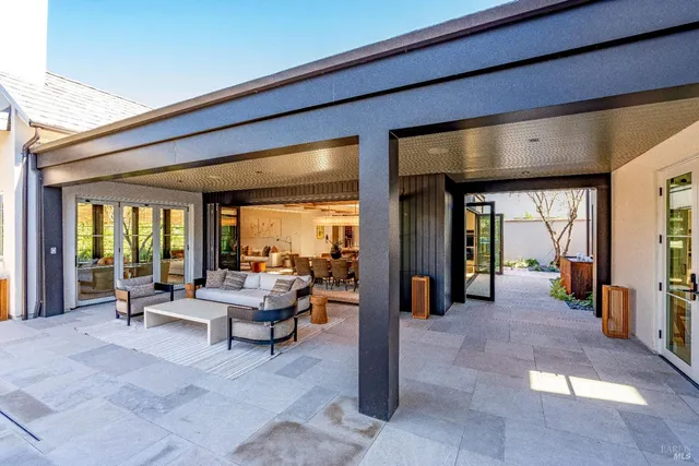 a view of an outdoor dining space with a table and chairs