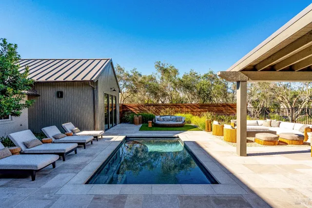 a view of a patio with couches chairs and a fire pit