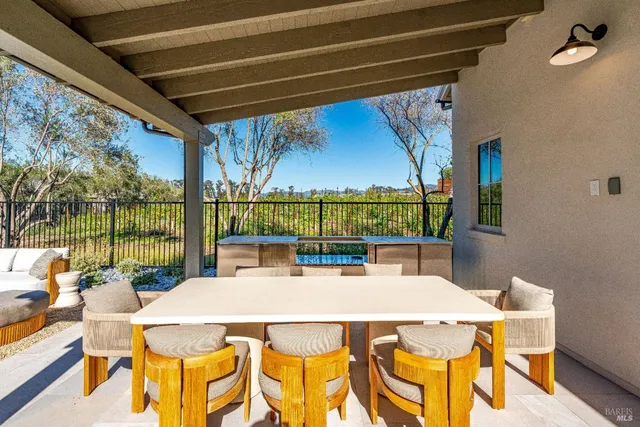 a view of a house with swimming pool and furniture